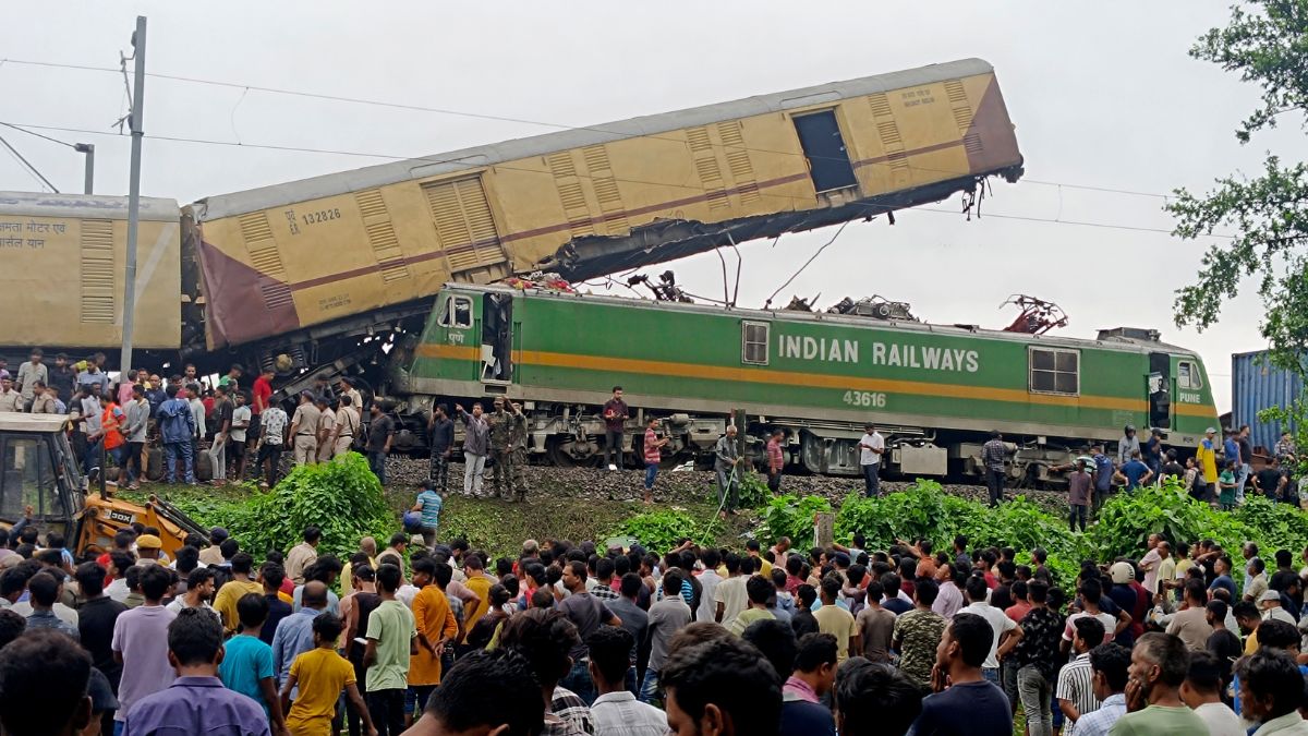 Onlookers watch as rescuers work after a cargo train rammed into Kanchanjunga Express, a passenger train, near New Jalpaiguri station, West Bengal on 17 June 2024. AP Onlookers watch as rescuers work after a cargo train rammed into Kanchanjunga Express, a passenger train, near New Jalpaiguri station, West Bengal on 17 June 2024. AP