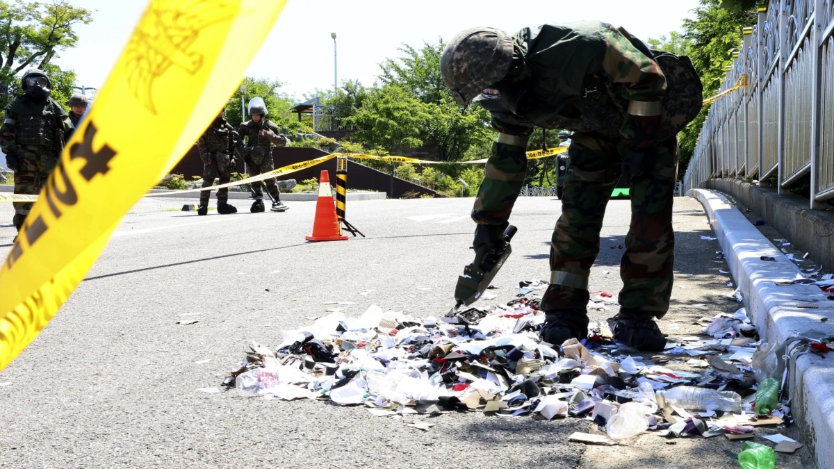 Soldiers inspect debris from a balloon sent by North Korea that landed in Incheon, South Korea. Source: AP Soldiers inspect debris from a balloon sent by North Korea that landed in Incheon, South Korea. Source: AP