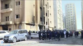  Rescuers arrive at the site of a building that caught fire in Kuwait. Source: AP