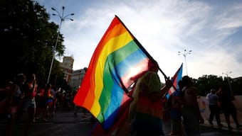 A person holds the pride flag during a Pride parade. Image used for representative purpose/ Reuters File