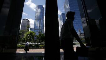 Office workers walk at a business district of Shenzhen, in China's southern Guangdong province. Reuters