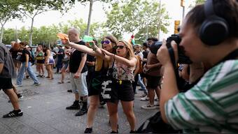 Protesters shoot water from water guns at tourists during a protest against mass tourism in Barcelona, Spain, July 6, 2024. Reuters