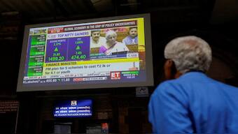 A man watches a screen displaying India's Finance Minister Nirmala Sitharaman's budget speech at a railway station in Mumbai, India, July 23, 2024. Reuters