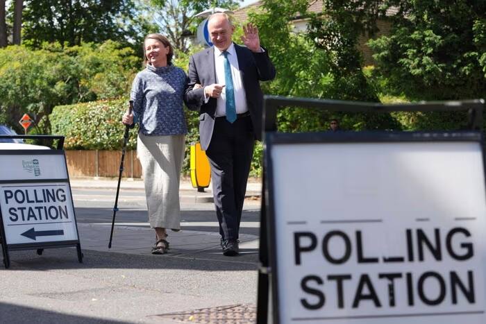 Britain’s LibDem party leader Ed Davey and his wife Emily Davey wave to the media in Kingston, London. AP