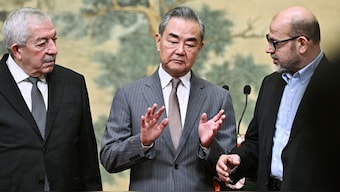(L-R) Mahmoud al-Aloul, Vice Chairman of the Central Committee of Palestinian organization and political party Fatah, China's Foreign Minister Wang Yi, and Mussa Abu Marzuk, senior member of the Palestinian Islamist movement Hamas, attend an event at the Diaoyutai State Guesthouse in Beijing on July 23, 2024. AFP