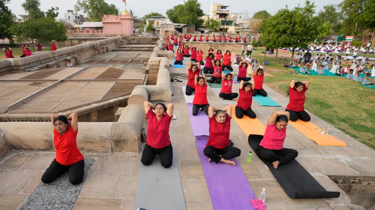 People perform yoga to mark International Yoga Day at Adalaj Step Well in Gandhinagar. AP People perform yoga to mark International Yoga Day at Adalaj Step Well in Gandhinagar. AP