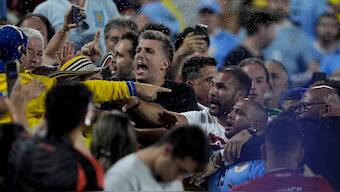 Uruguay players confront Colombia fans at the end of a Copa America semi-final match in Charlotte. AP