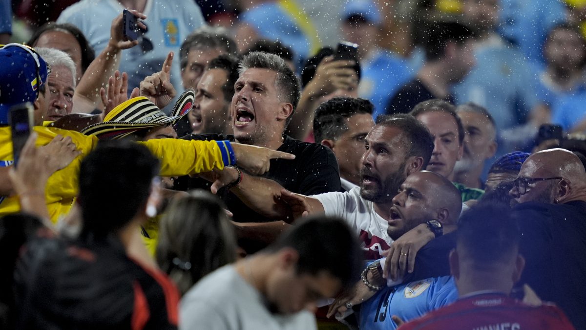 Uruguay players confront Colombia fans at the end of a Copa America semi-final match in Charlotte. AP Uruguay players confront Colombia fans at the end of a Copa America semi-final match in Charlotte. AP