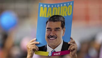 A supporter displays a poster of Venezuela's President Nicolas Maduro during his closing election campaign rally in Caracas, Venezuela. (Photo: AP)
