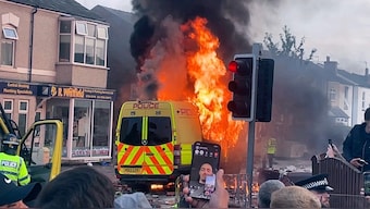 A police van burns as an unruly crowd clashed with police, Tuesday, July 30, 2024, in Southport, northwest England, near where three girls were stabbed to death in a dance class the day before. AP