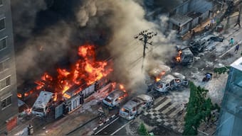 Smoke rises from the burning vehicles after protesters set them on fire near the Disaster Management Directorate office, during the ongoing anti-quota protest in Dhaka. AFP