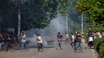 People run as police fire teargas during a coffin rally of anti-quota protesters at the University of Dhaka, July 17, 2024. Source: REUTERS.