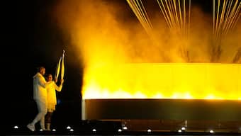 Olympic torch bearers Marie-Jose Perec and Teddy Riner light the cauldron at the Paris Olympics opening ceremony. AP