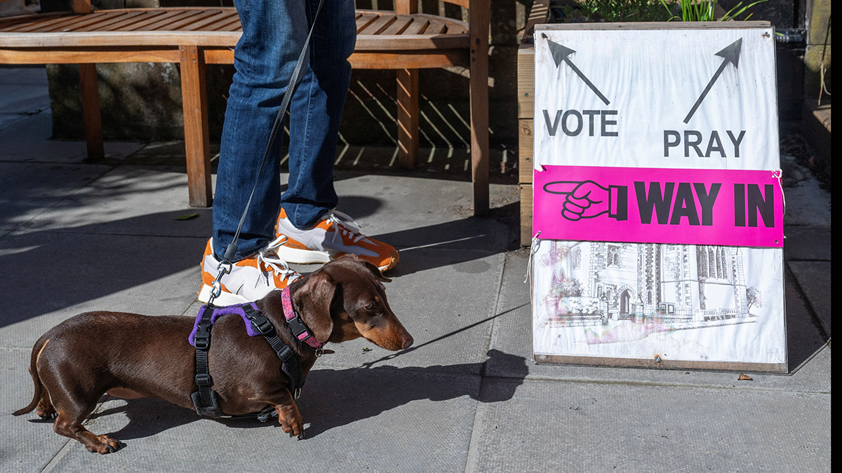 A person and a dog wait outside St James' Church polling station during the general election in Edinburgh, Scotland, Britain, July 4, 2024. Reuters A person and a dog wait outside St James' Church polling station during the general election in Edinburgh, Scotland, Britain, July 4, 2024. Reuters