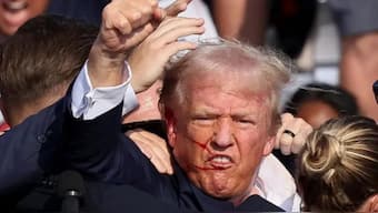 Republican presidential candidate and former President Donald Trump is escorted away by security personnel after gunfire rang out during a campaign rally at the Butler Farm Show in Butler, Pennsylvania, July 13, 2024. Reuters