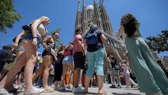 Tourists standing in front of the Sagrada Familia basilica in Barcelona, on July 5. PHOTO: AFP

