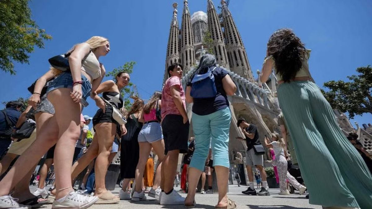 Tourists standing in front of the Sagrada Familia basilica in Barcelona, on July 5. PHOTO: AFP
Tourists standing in front of the Sagrada Familia basilica in Barcelona, on July 5. PHOTO: AFP