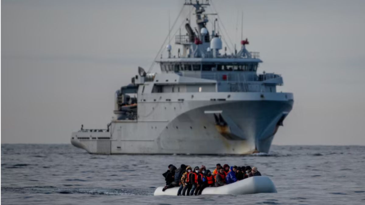 An inflatable dinghy carrying migrants passes a French navy vessel as it heads towards England in the English Channel, Britain, May 4, 2024.- Reuters  An inflatable dinghy carrying migrants passes a French navy vessel as it heads towards England in the English Channel, Britain, May 4, 2024.- Reuters