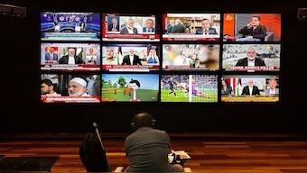 A person watches the news on multiple TV screens, most of them announcing the killing of senior Hamas leader Ismail Haniyeh, in Istanbul, Turkey, on Wednesday. Reuters