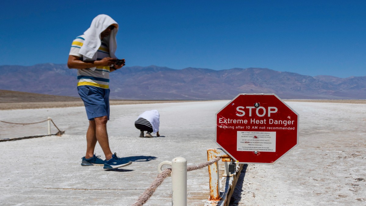 Two people cover themselves in white towels as they walk around Badwater Basin in Death Valley National Park, Calif. AP Two people cover themselves in white towels as they walk around Badwater Basin in Death Valley National Park, Calif. AP