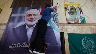 A man hangs a picture of Hamas leader Ismail Haniyeh who was assassinated early on Wednesday morning in Iran, at Burj al-Barajneh Palestinian refugee camp in Beirut, Lebanon July 31, 2024. Reuters