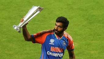 Jasprit Bumrah displays the T20 World Cup trophy during the Indian team's lap of honour around Mumbai's Wankhede Stadium on Thursday, 4 July. Reuters