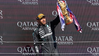 Mercedes driver Lewis Hamilton of Britain celebrates on the podium after winning the British Formula One Grand Prix race at the Silverstone racetrack. AP