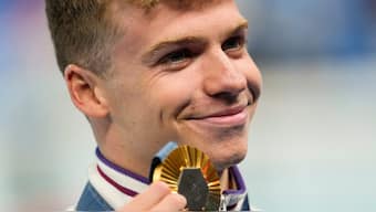 Gold medalist, Leon Marchand, of France, poses after the men's 400-meter individual medley final at the 2024 Summer Olympics. AP
