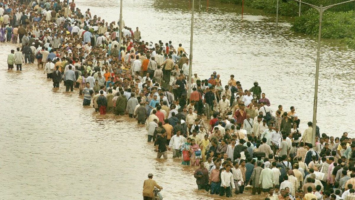 (File) Commuters walk through floodwaters after heavy torrential rains paralysed the city of Mumbai on 27 July 2005. AFP (File) Commuters walk through floodwaters after heavy torrential rains paralysed the city of Mumbai on 27 July 2005. AFP