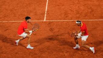Carlos Alcaraz (L) and Rafael Nadal (R) celebrate during their doubles match at Roland Garros during the Paris Olympics. AP