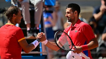 Novak Djokovic (R) shakes hands with Rafael Nadal (L) after winning his second round match at the Paris Olympics. AFP