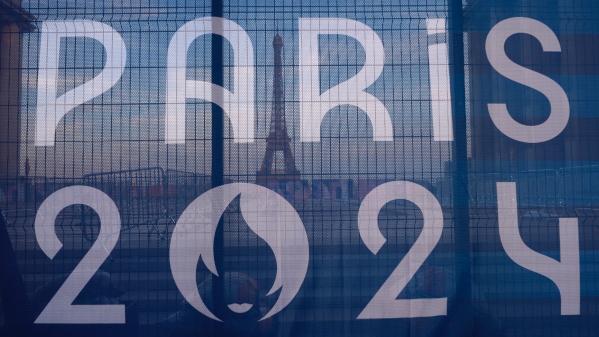 The Eiffel Tower is seen behind a Paris Olympics canvas. AP The Eiffel Tower is seen behind a Paris Olympics canvas. AP