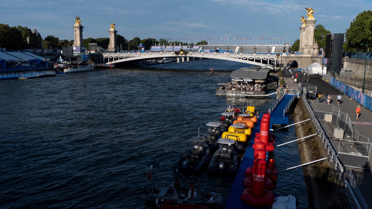 Watercraft and buoys sit along the Seine river as the triathlon event venue on the Pont Alexandre III bridge stands in the background at the 2024 Summer Olympics in Paris. AP Watercraft and buoys sit along the Seine river as the triathlon event venue on the Pont Alexandre III bridge stands in the background at the 2024 Summer Olympics in Paris. AP