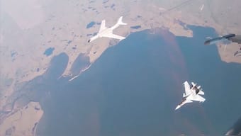 A H-6K bomber of the Chinese People's Liberation Army (PLA) Air Force is accompanied by a Russian Sukhoi Su-30CM jet fighter during joint Russian and Chinese military plane patrols near the US state of Alaska, in this still image from video released July 25, 2024. Russian Defence Ministry via Reuters