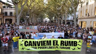 Protesters hold a banner which reads as “Let's change course” as they take part in a demonstration against overtourism and housing prices on the island of Mallorca in Palma de Mallorca. AFP