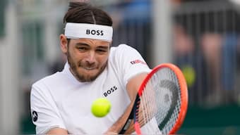 Taylor Fritz plays a backhand return to Arthur Rinderknech during their second round match at Wimbledon. AP