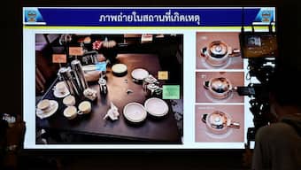 A screen shows a picture from the crime scene with teacups in which cyanide was found, during a presser following a case of six foreign nationals who were found dead in a room in a plush Bangkok hotel at Lumpini Police Station, in Bangkok, Thailand, July 17, 2024. Reuters