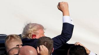 Donald Trump assisted by his secuity officials after the assasination attempt. Reuters file