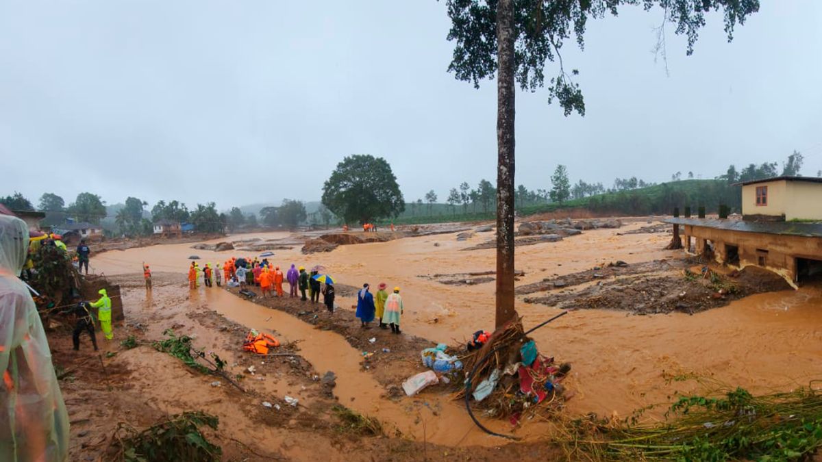 Rescuers and others inspect the spot after landslides hit hilly villages in Wayanad district, Kerala state, July 30, 2024. AP Rescuers and others inspect the spot after landslides hit hilly villages in Wayanad district, Kerala state, July 30, 2024. AP