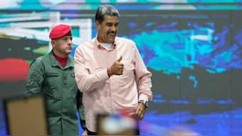 Venezuelan President Nicolas Maduro, right, gestures during a meeting with international observers in Caracas, Venezuela. AP