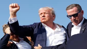 Republican presidential candidate former President Donald Trump is rushed offstage during a rally on July 13, 2024 in Butler, Pennsylvania. AFP