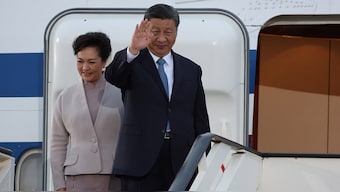 (File) Chinese President Xi Jinping waves next to his wife Peng Liyuan as they board their plane for departure following a two-day state visit, at Nikola Tesla Airport in Belgrade, Serbia, on 8 May, 2024. Reuters
