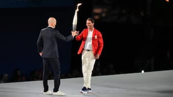 Zinedine Zidane hands the Olympic torch over to Rafael Nadal during the opening ceremony of the 2024 Summer Olympics. AP
