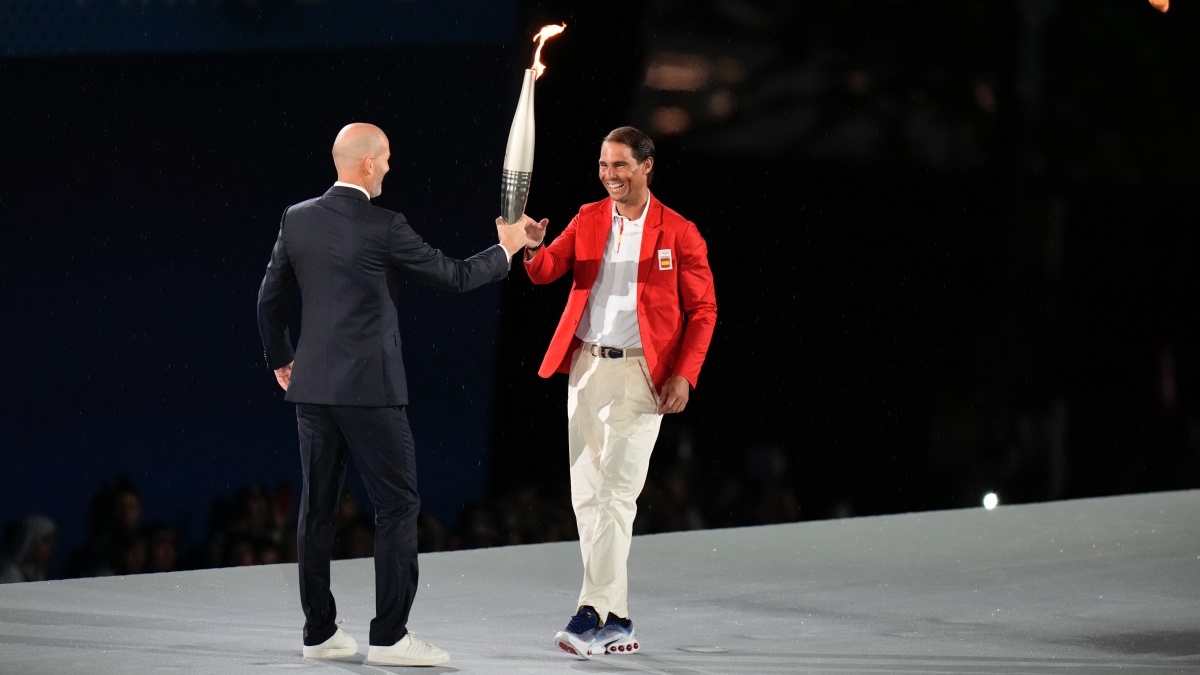 Zinedine Zidane hands the Olympic torch over to Rafael Nadal during the opening ceremony of the 2024 Summer Olympics. AP Zinedine Zidane hands the Olympic torch over to Rafael Nadal during the opening ceremony of the 2024 Summer Olympics. AP