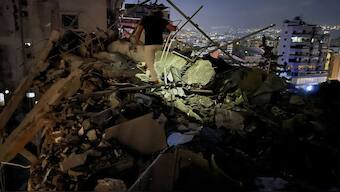 A man inspects a destroyed building that was hit by an Israeli airstrike in the southern suburbs of Beirut, Lebanon. AP