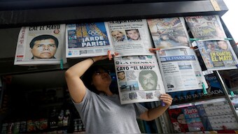 A newspaper seller arranges newspapers reporting the El Paso, Texas, U.S., arrest of Mexican drug lord Ismael "El Mayo" Zambada and Joaquin Guzman Lopez, "El Chapo" Guzman's son, in Mexico City, Mexico. Reuters File 