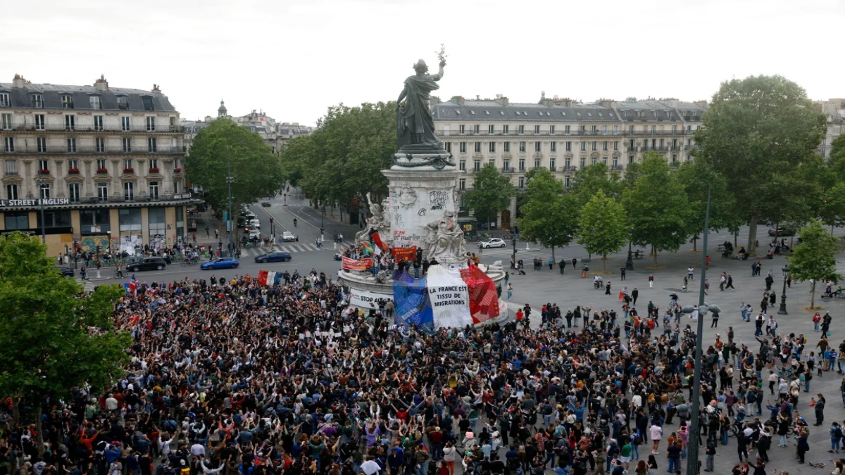 A giant French flag reads "France is born out of migration," at an event in Republique Square in Paris. AFP A giant French flag reads "France is born out of migration," at an event in Republique Square in Paris. AFP