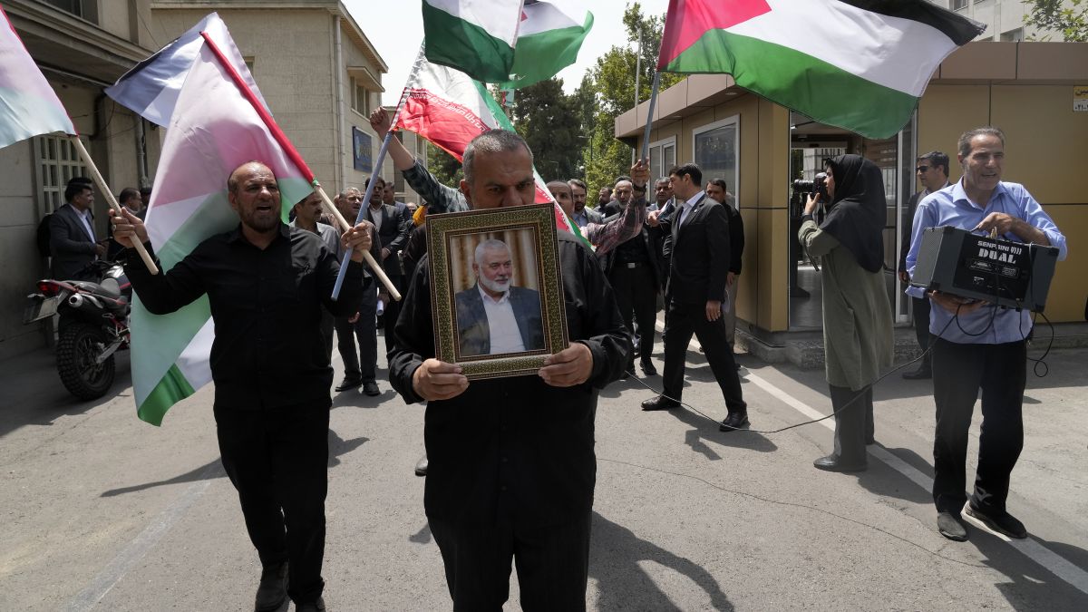 Members of Tehran University Council attend a protest to condemn the killing of Hamas leader Ismail Haniyeh, as they carry Iranian and Palestinian flags at the University in Tehran, Iran. AP Members of Tehran University Council attend a protest to condemn the killing of Hamas leader Ismail Haniyeh, as they carry Iranian and Palestinian flags at the University in Tehran, Iran. AP