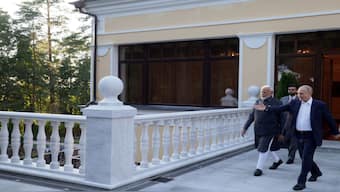 Russia's President Vladimir Putin shows the way to India's Prime Minister Narendra Modi during their meeting at the Novo-Ogaryovo state residence near Moscow, Russia. Reuters
