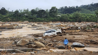 A damaged car lies amid debris after landslides hit hilly villages in Wayanad district in Kerala. AP